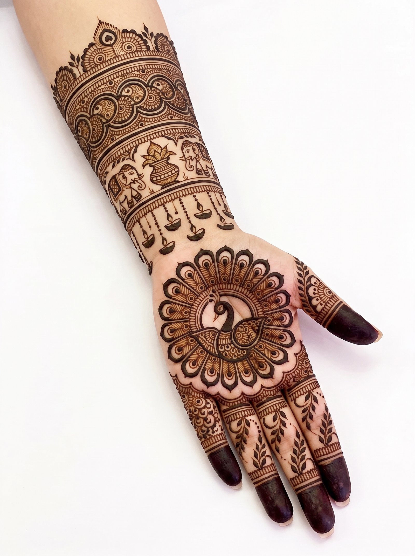 Intricate bridal mehndi design with a peacock centerpiece, paisley motifs, floral patterns, and detailed wrist bands.