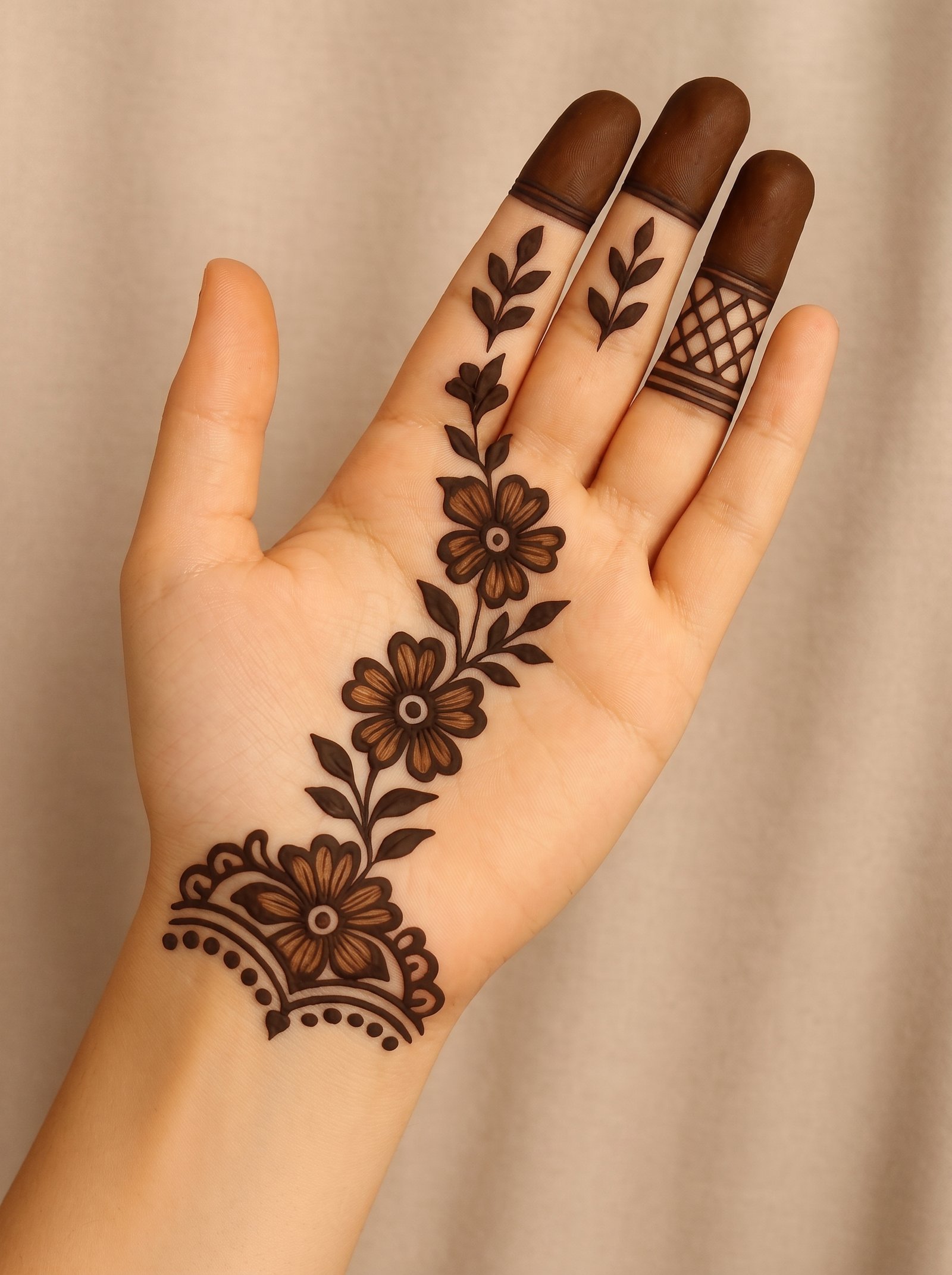 Simple front hand mehndi design with floral vines, leafy motifs, bold fingertips, and a decorative wrist pattern
